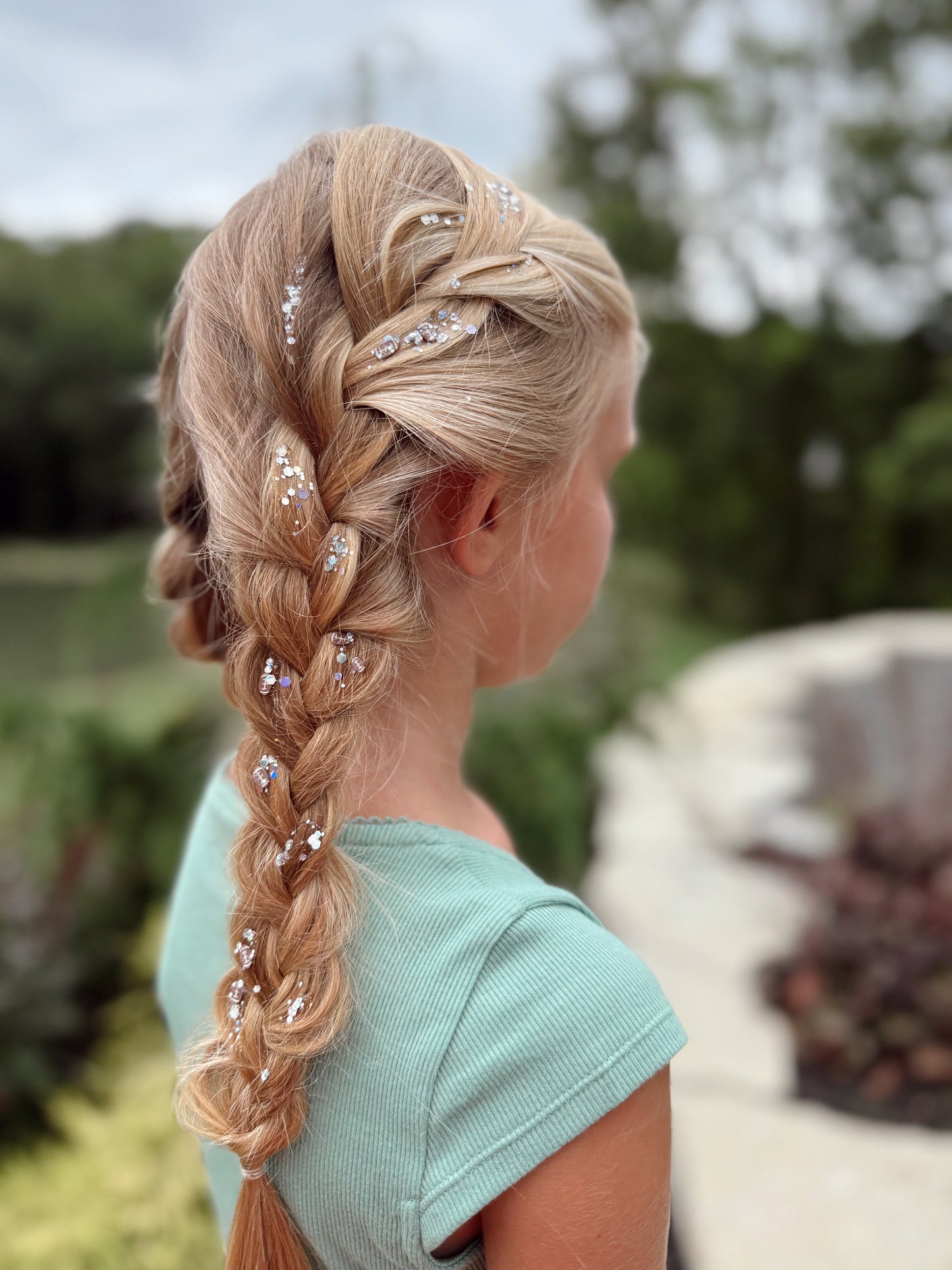 Back view of blonde braided hairstyle decorated with Friday Night Lights Pixie Paste football hair glitter, safe and biodegradable sparkle gel.
